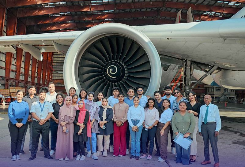 MCAS students gathered beside a jet engine